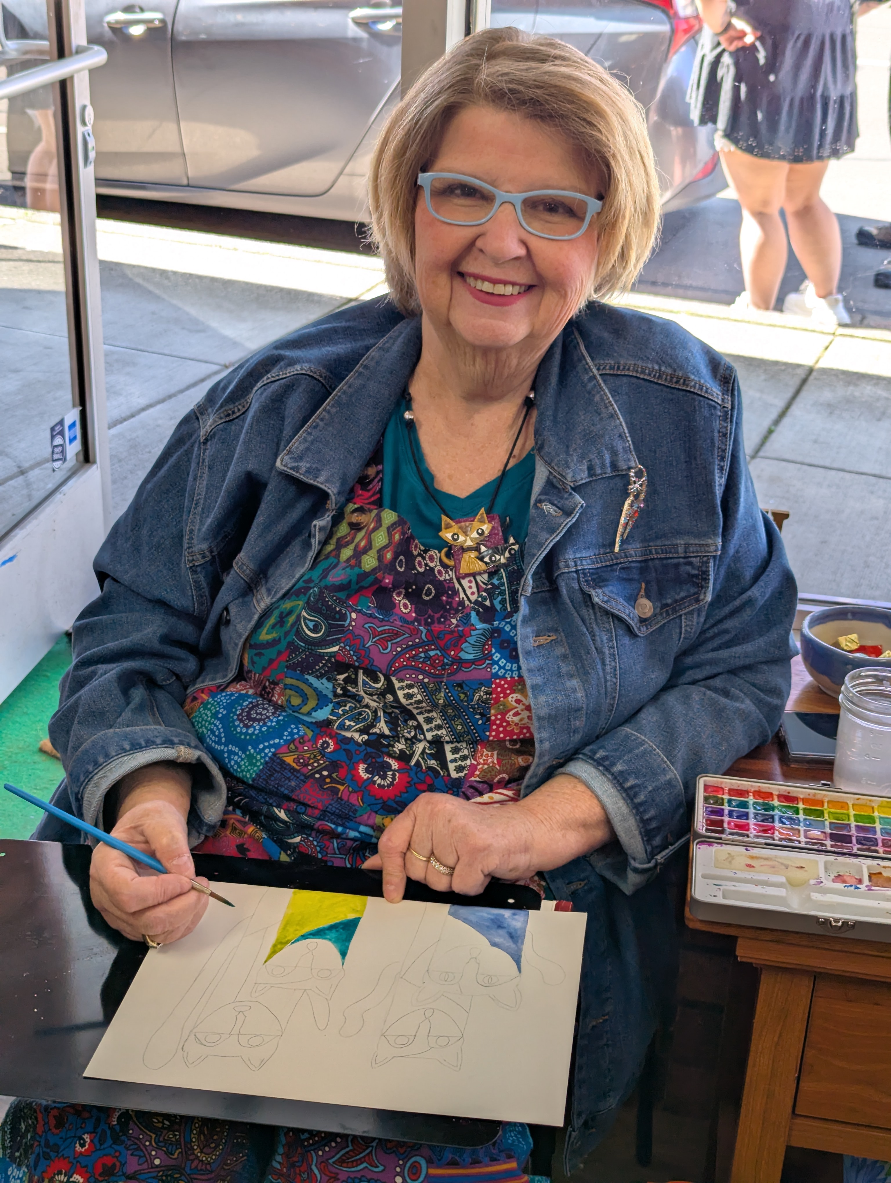 Joy Stone, mixed media artist, working on a watercolor painting.