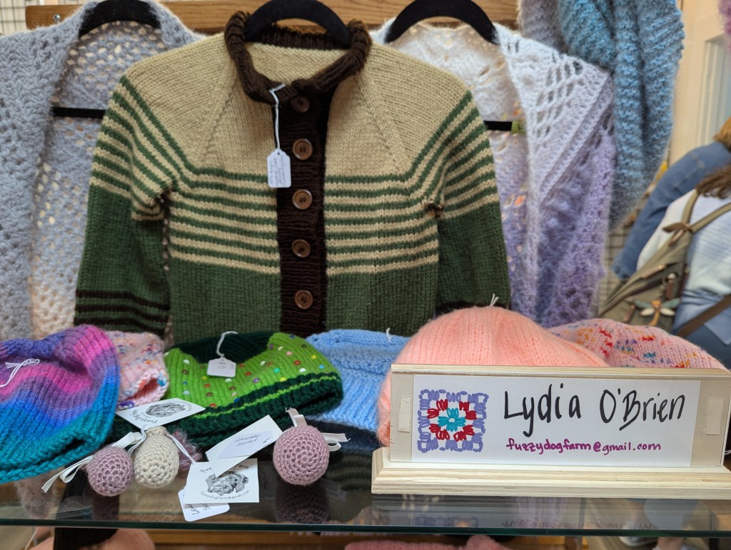 A knit brown striped sweater and a variety of knit hats. 